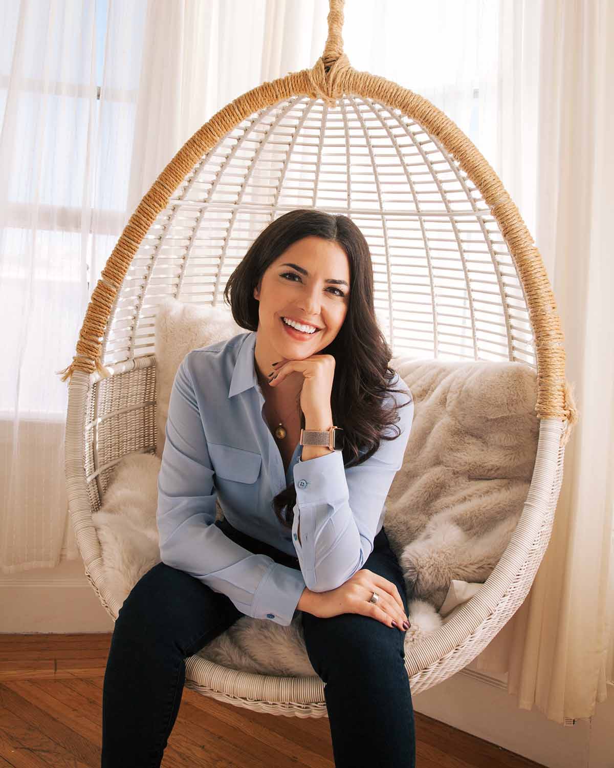 dr molly smiling casually in hanging chair
